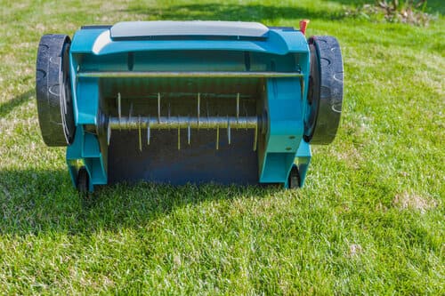 A lifted aerator rental on a cleanly fresh-cut lawn.